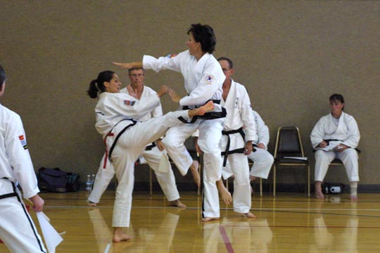 Two woman spar during a tournament match.